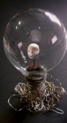 Carved drug, wooden base, globe-bulb on silver wire in an old glass and brass box • 12x15,5x12cm • More pic. GALLERY SCULPTURES