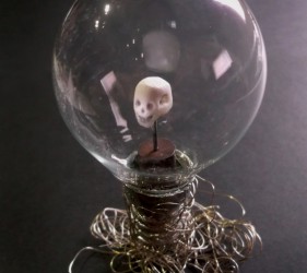 Carved drug, wooden base, globe-bulb on silver wire in an old glass and brass box • 12x15,5x12cm • More pic. GALLERY SCULPTURES